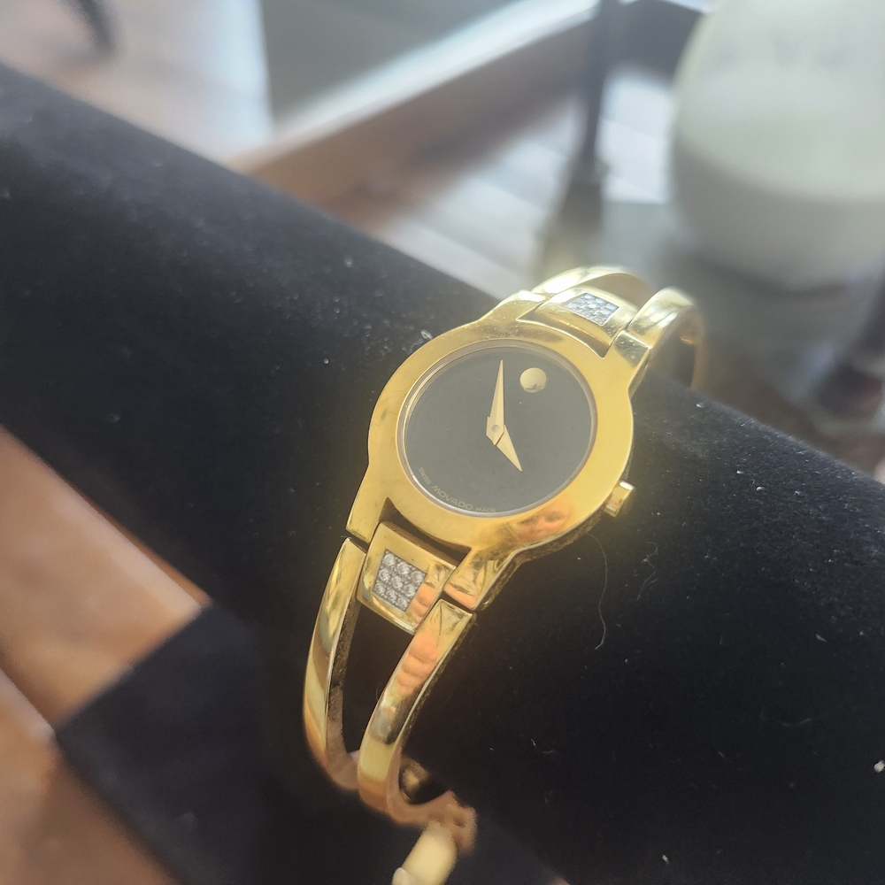 Movado Gold and Diamind Black Face Watch with Elegant Design